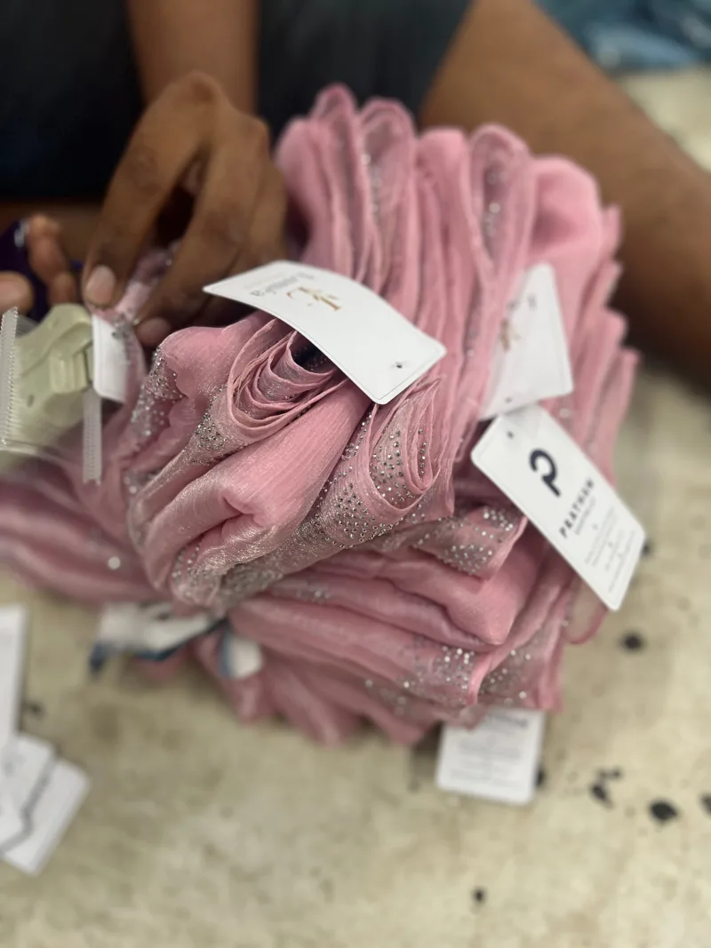 Tagging embellished scarves before packing