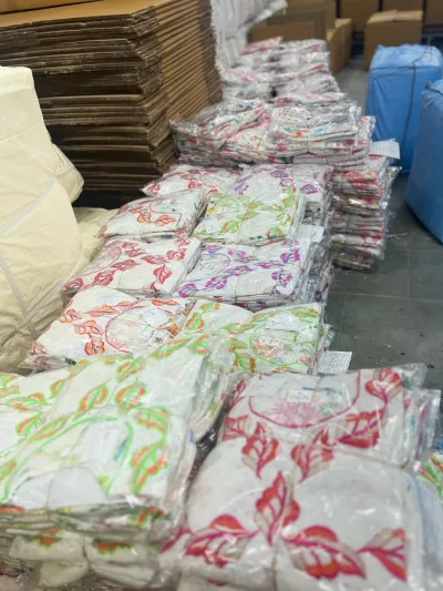 Embroidered garments packed and stacked for an order