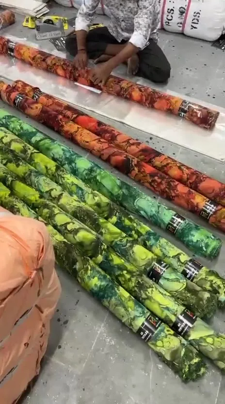 Rolling and wrapping printed fabric for an order