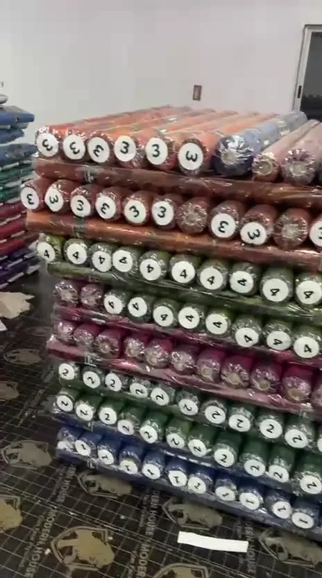 Numbered fabric rolls stacked and ready for dispatch